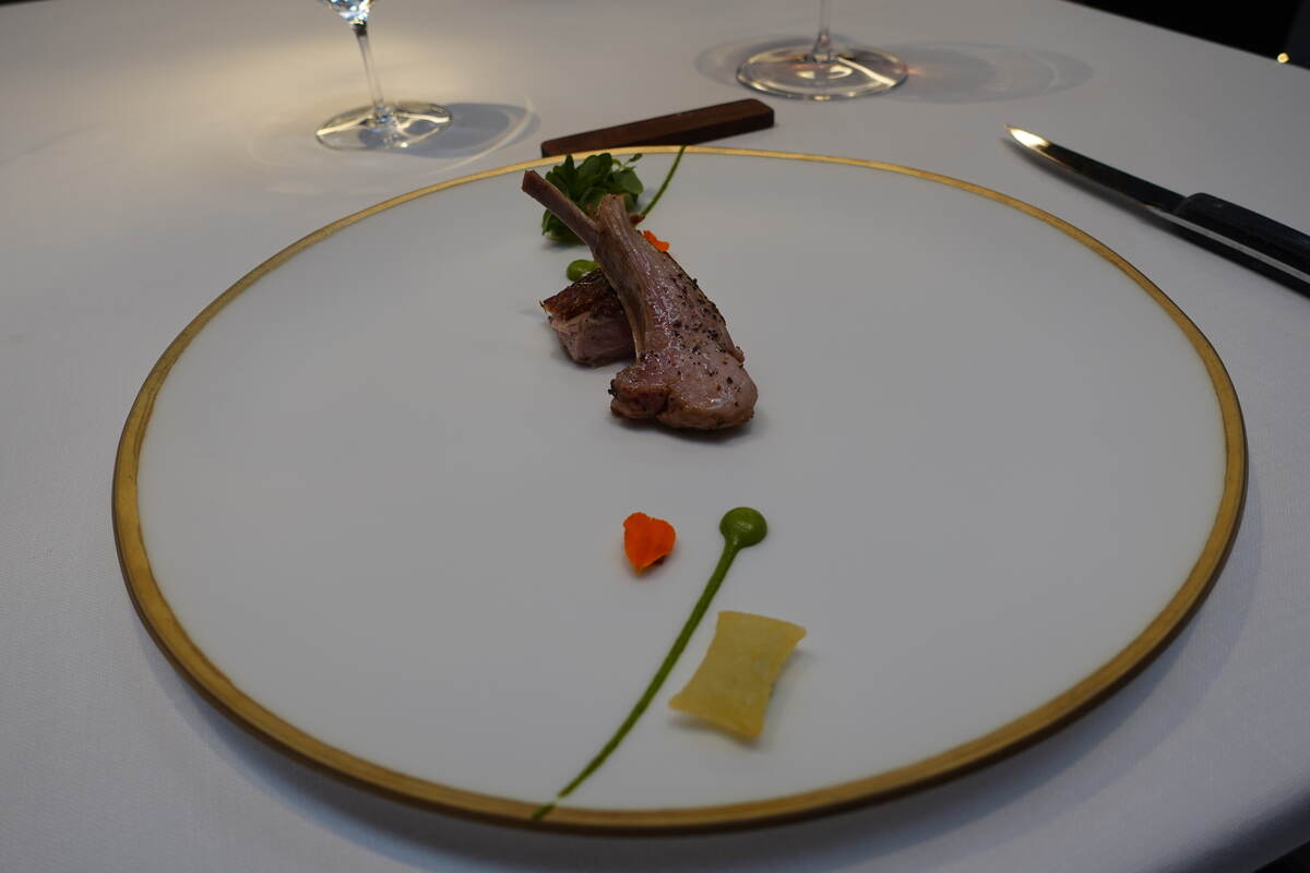 Aged suckling lamb with herbs, Padrón peppers, soufflé potatoes and ají