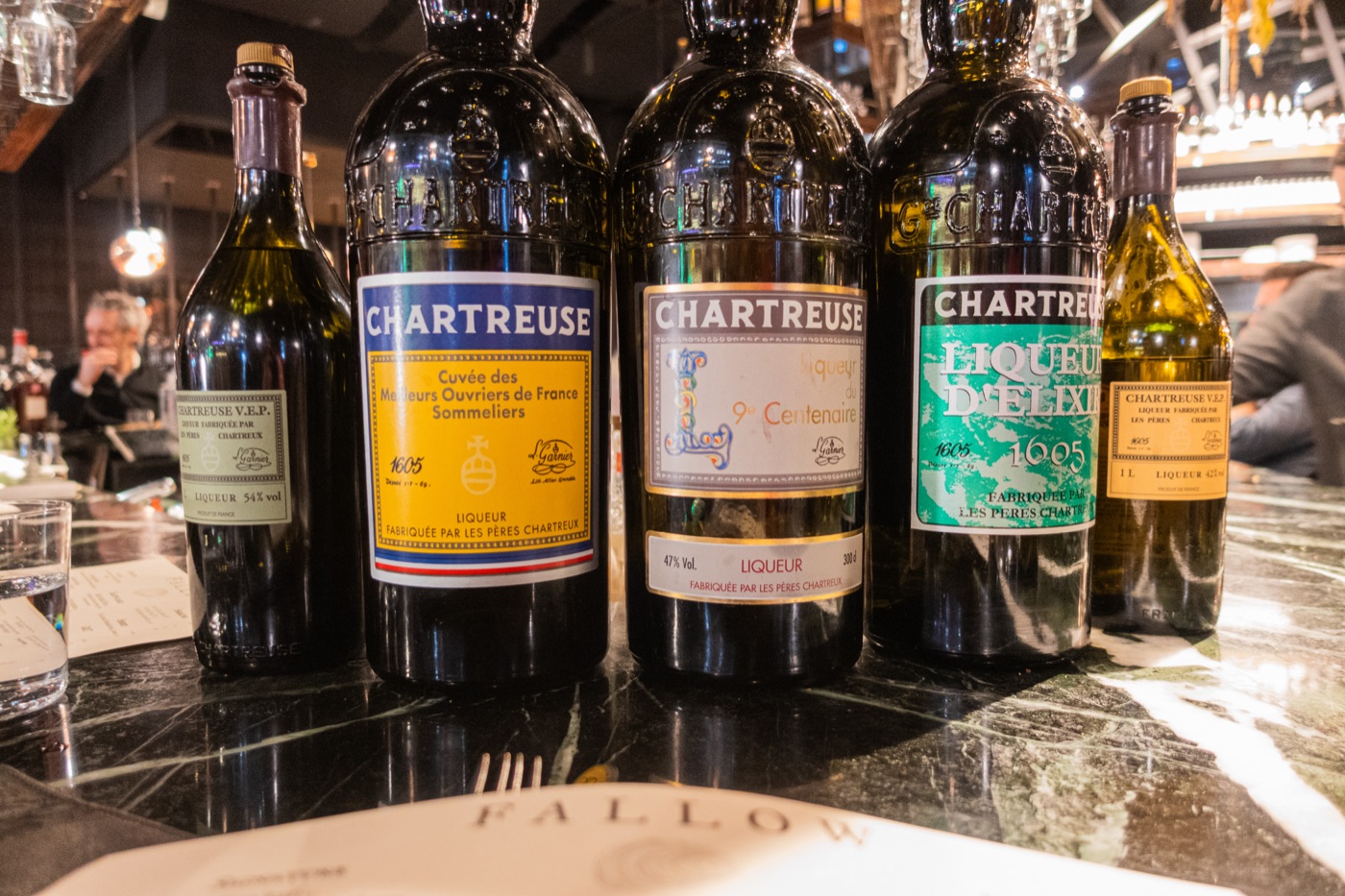 Chartreuse, lined up behind the bar.
